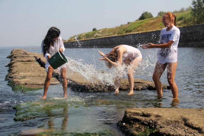 Girls have fun while splash water on each other
