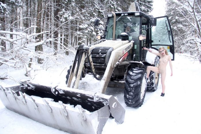 Naked Eva Gold posing on tractor