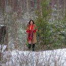 Russian brunette Daria posing at snowy forest