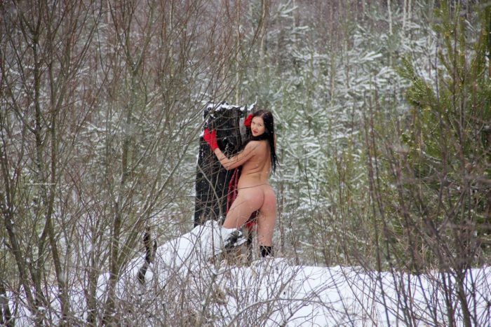 Russian brunette Daria posing at snowy forest