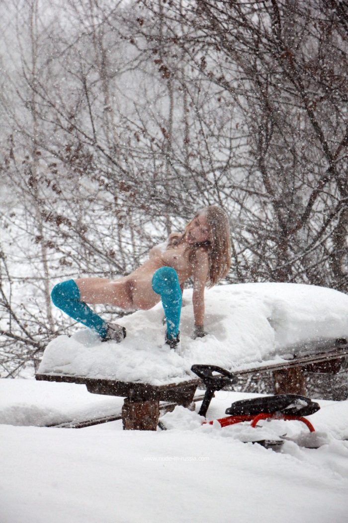 Sexy russian blonde posing outdoors during snowfall