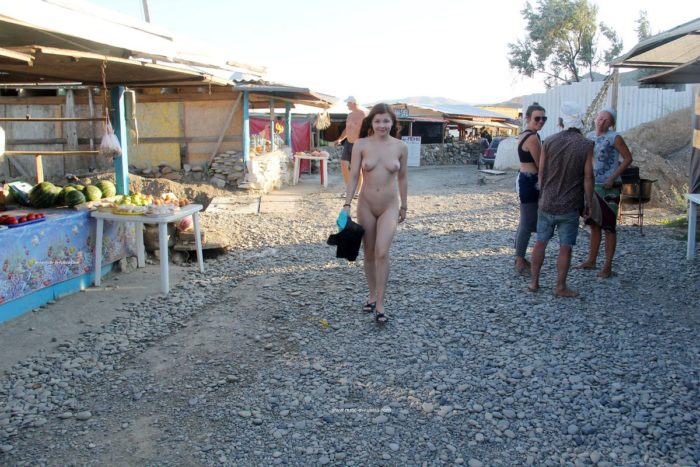 Shameless teen Renara walks naked at small market