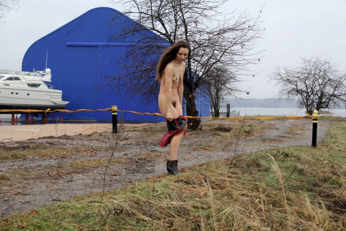 Skinny teen Natalia K undresses outdoors