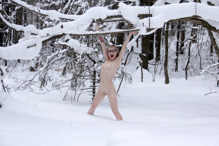 Smiling blonde Eva Gold posing at snowy forest