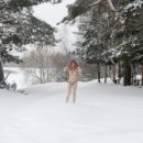 Sweet blonde Seshat plays with a snow