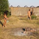 Two girls play badminton naked
