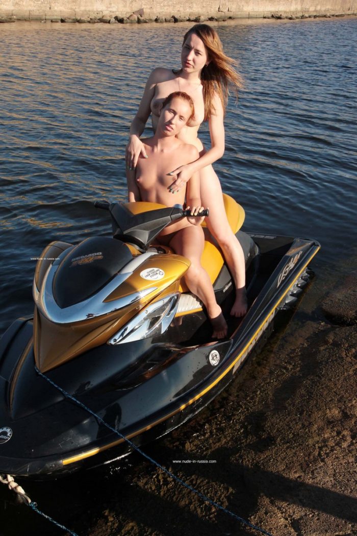 Two really hot babes posing on water scooter