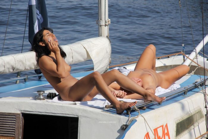 Young girls relaxing on boat with no clothes