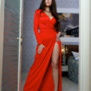 Martina Mink shows off her amazing body  as she strips her sexy, red dress on the bed.