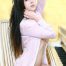 Alina J flaunts her body beside a piano