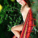 Malinka A relaxes naked in a hammock