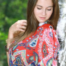 Marta E playing outside in a vibrant paisley romper