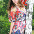 Marta E playing outside in a vibrant paisley romper