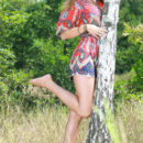 Marta E playing outside in a vibrant paisley romper