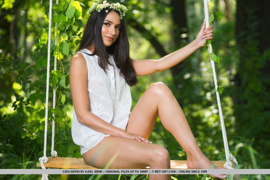 Cira Nerri looks gorgeous in white. She goes naked while posing sitting on the swing.