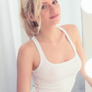 Watch Monique C tease out of her clothes while she gets ready in a mirror.