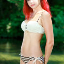 A fun and playful redhead named Beata C debuts with her tight yet curvy body.
