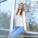 Aileen takes off her sweater and jeans then poses her slender body on the wood floor.