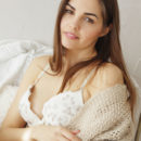 Alise Moreno sensually strips on the couch as she bares her nubile body.