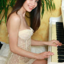 Flora C gently caresses her fingers down the piano, posing in her see-through, yellow babydoll before she slips out of it to reveal her delightful breasts, tiny waist, and her heavenly little pussy.
