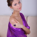 Garbed in a sliky lavendar robe and purple panty, Irina J spreads her legs wide open on top of the couch.