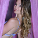 In sheer lingerie, Stefania Beatty looks sweet under a sheer canopy.