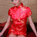 Irina B exudes a sultry doll dressed in a bright red cheongsam.