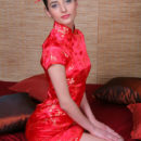 Irina B exudes a sultry doll dressed in a bright red cheongsam.