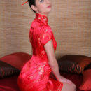 Irina B exudes a sultry doll dressed in a bright red cheongsam.