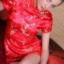 Irina B exudes a sultry doll dressed in a bright red cheongsam.