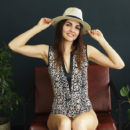 Alise Moreno strips out of her cheetah printed bodysuit then fingers herself on the leather chair.