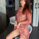 Brown-haired Nedda A looks stunning in her mesh dress in the kitchen. She then poses naked on the bar stool and kitchen counter.