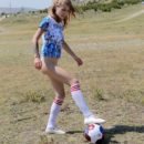 Gorgeous blonde Eva Gold plays football bottomess with hairy pussy