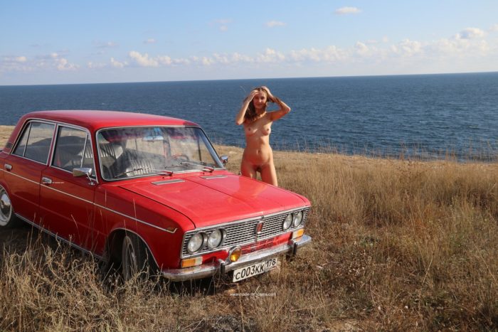 Lovely teen Valentina K near old car