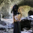 Muslim girl undresses in ruins