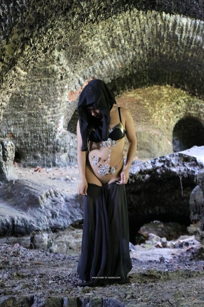 Muslim girl undresses in ruins