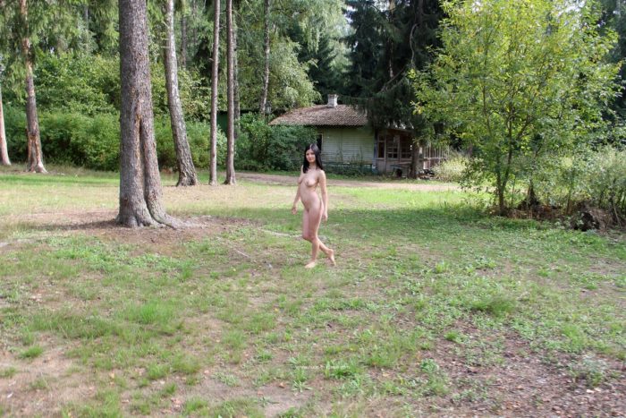 Naked brunette at abandoned camp