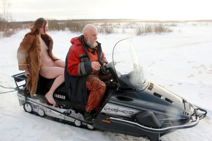 Redheaded Alina S rides snowmobile with a stranger