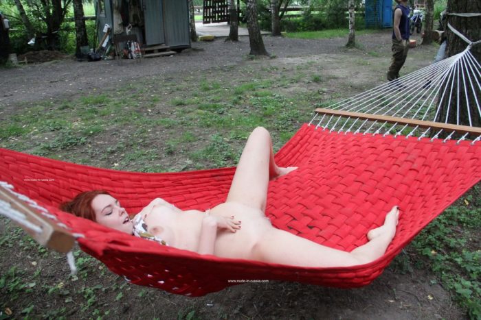 Redheaded teen masturbates in hammock