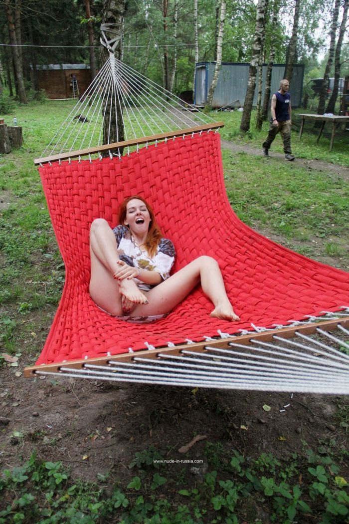 Redheaded teen masturbates in hammock