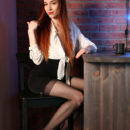 Sherice strip teases while sitting on a high chair. She leaves her black stockings on and poses on the table too.