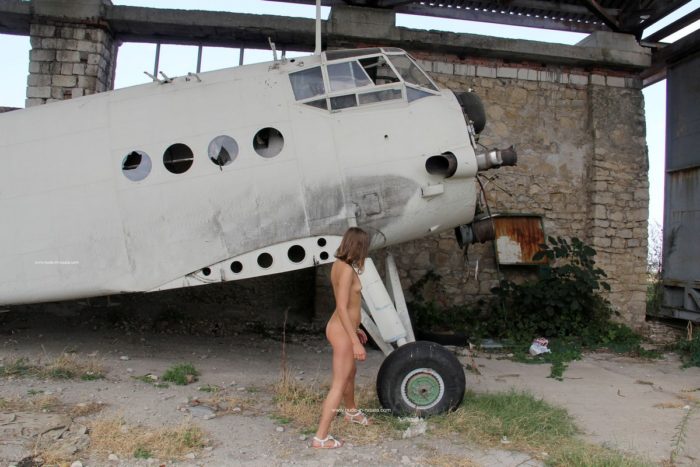 Small-tittied Olga W near old planes