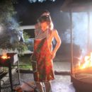 Two naked hotties cook BBQ at night