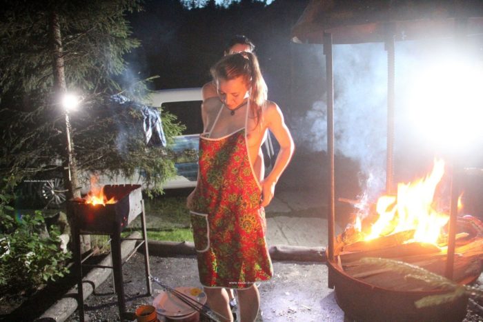 Two naked hotties cook BBQ at night