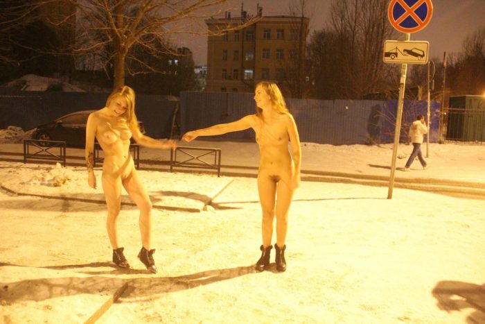 Two sexy ladies walks at winter streets