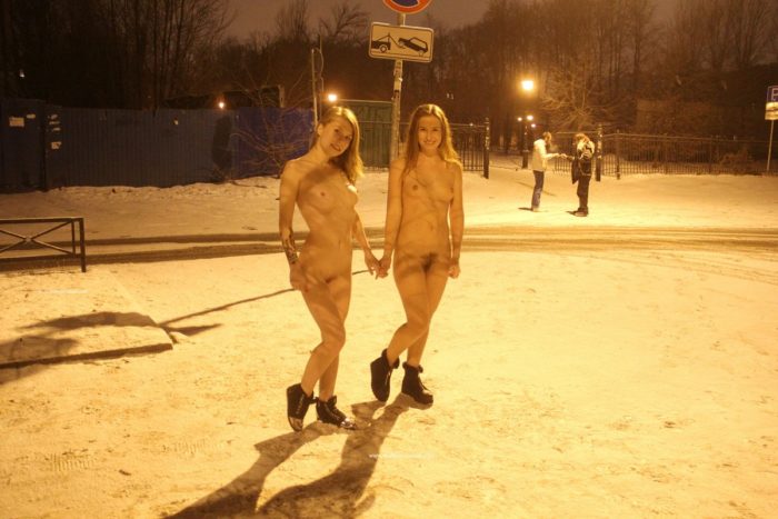 Two sexy ladies walks at winter streets