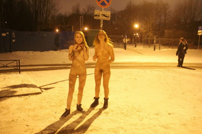 Two sexy ladies walks at winter streets