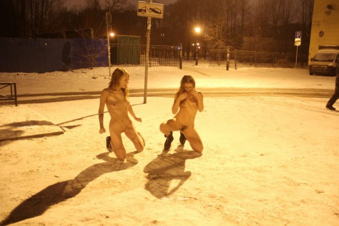 Two sexy ladies walks at winter streets