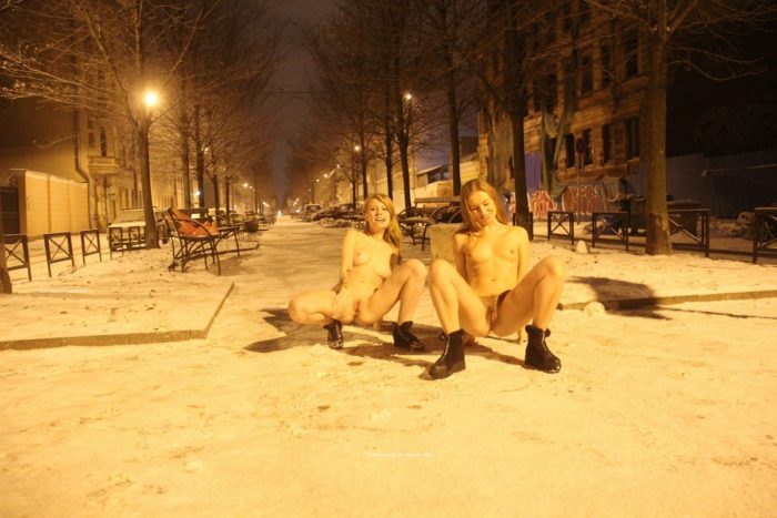 Two sexy ladies walks at winter streets