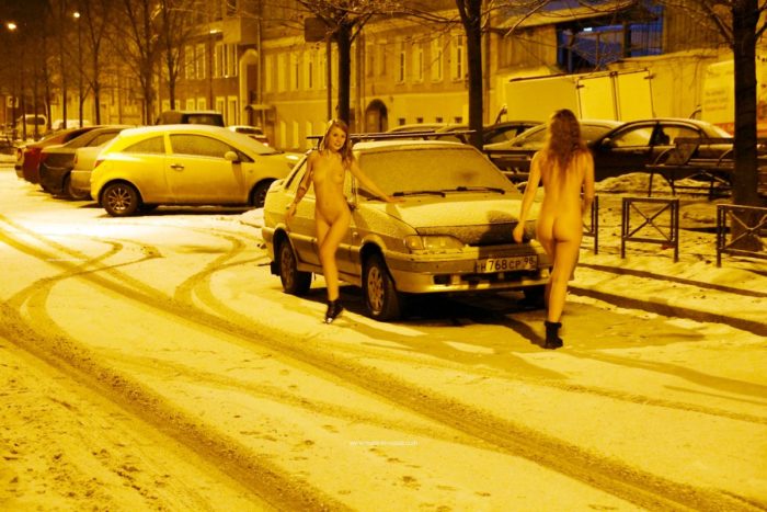 Two sexy ladies walks at winter streets